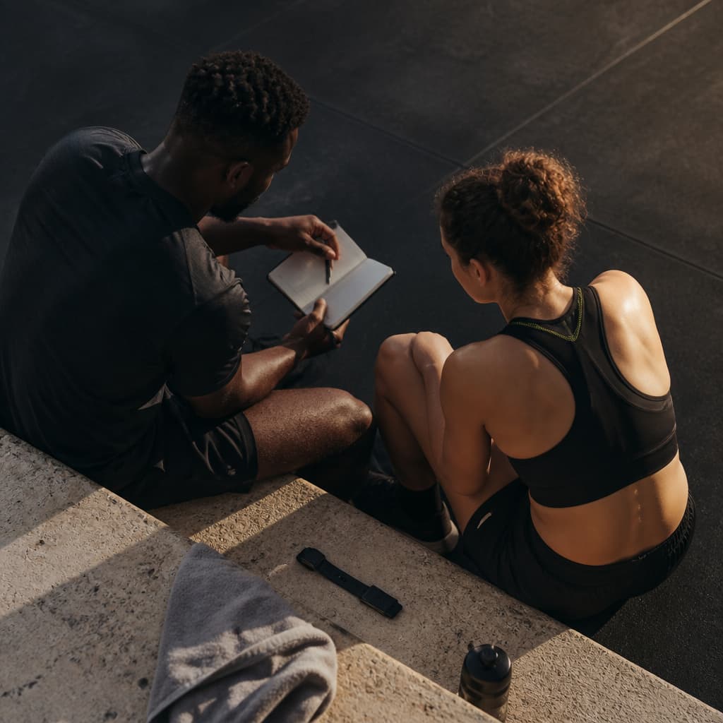 Athlete and coach document a training decision after a session.